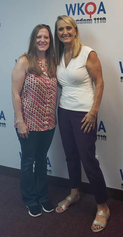 Drs. Christine Bacon and Jessica McCleese stand togehter smiling at the WKQA studios in Hampton Roads, Virginia. 