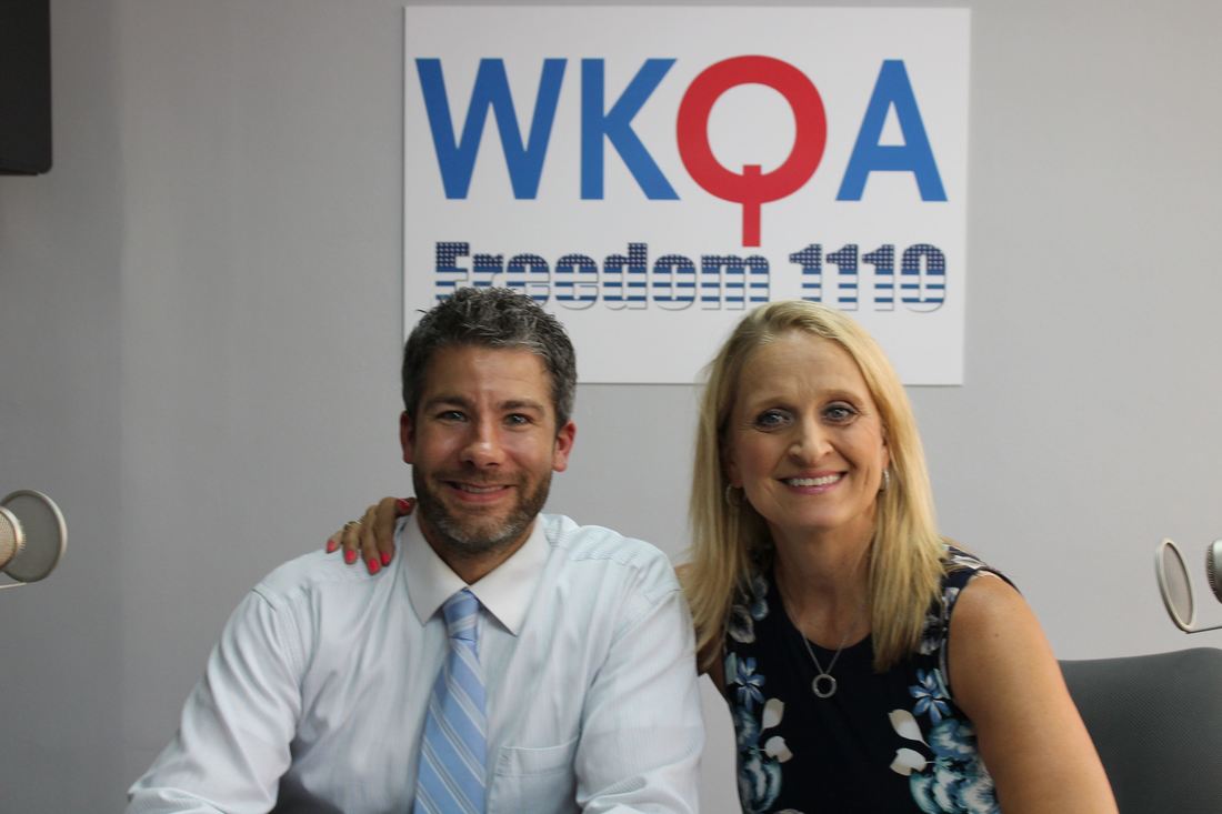 Seth Doherty and Dr. Christine Bacon behind the broadcast desk at WKQA.
