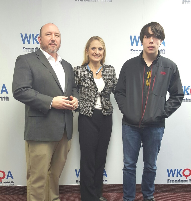 Dr. Christine Bacon and guests Toby DeBause and son Will at the WKQA studio