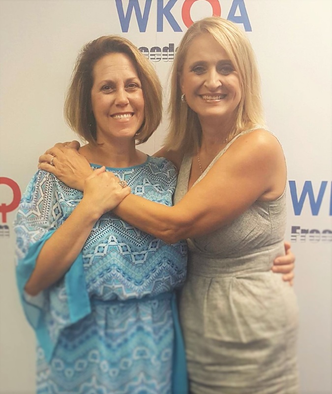 Guest Ellen Petko gets hugged by host, Dr. Christine Bacon at the WKQA studios.