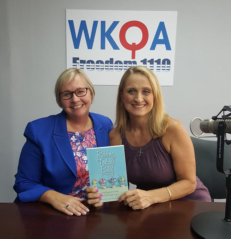 Dr. Melanie Wilhelm and Dr. Christine Bacon behind the microphone in the WKQA studios.