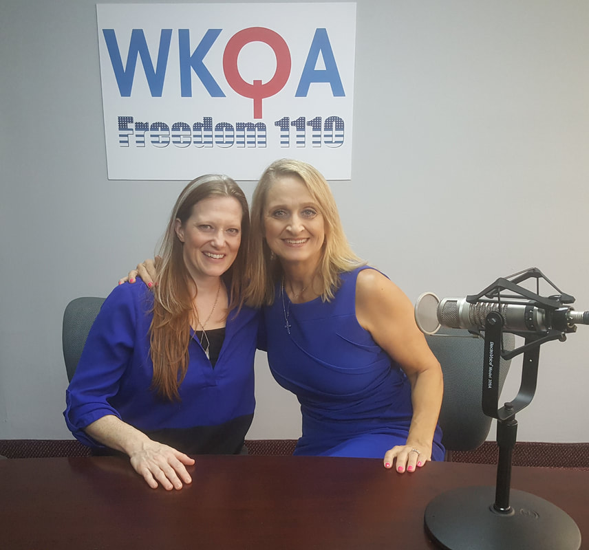 Drs. Christine Bacon and Jessica McCleese behind the broadcast desk at the WKQA studio.