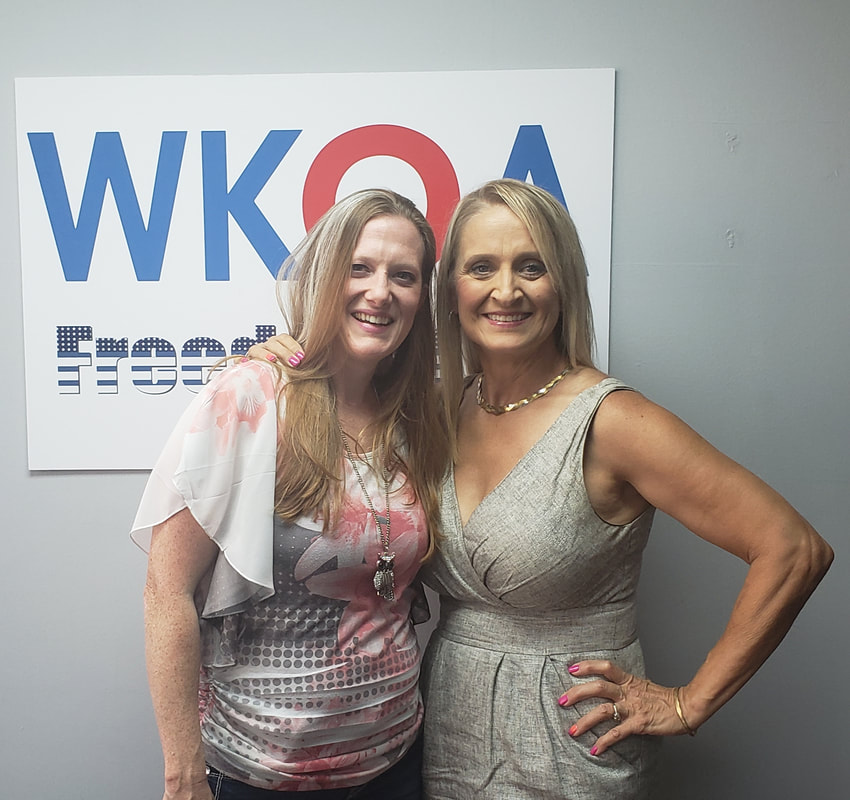 The two lady doctors hug an smile for the camera after another great radio show.