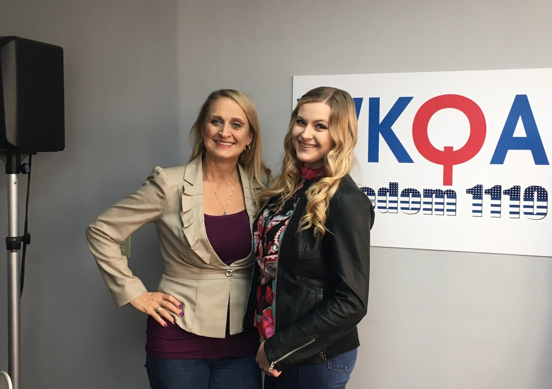 Kara Bohrer and Christine Bacon standing in the WKQA studios.