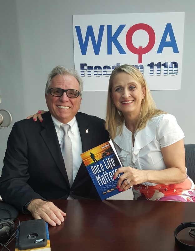 Guest and author Marty Angelo shares a laugh with Dr. Christine Bacon in the WKQA studios in Norfolk, Virginia.