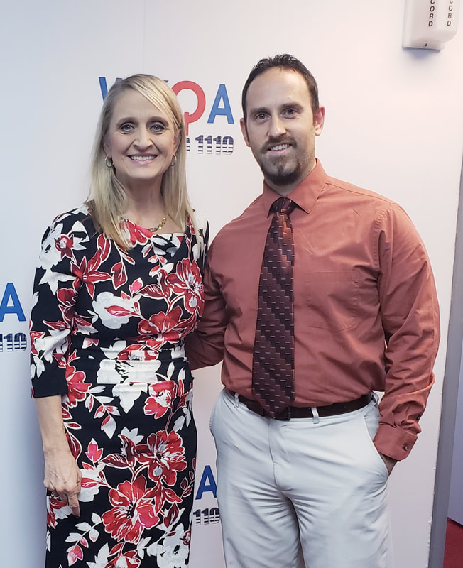 Dr. Christine Bacon and Ryan Hopkin stand in the WKQA studios in Norfolk Virginia.