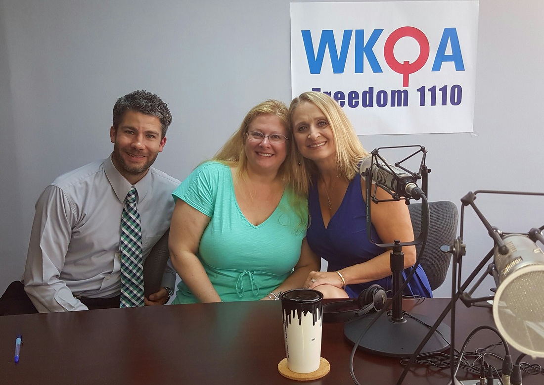 Seth Doherty and Amy Chuzinski sit with Dr. Christine Bacon at the radio microphones at the WKQA studios
