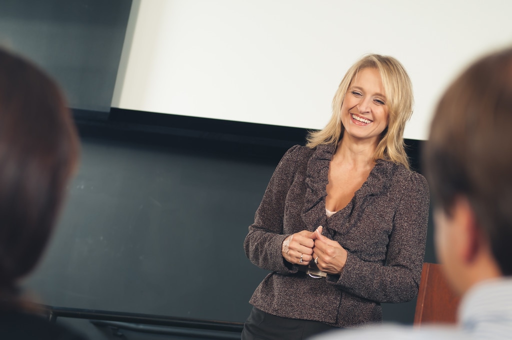Dr. Christine Bacon laughs as she discusses the principles of an extremely happy marriage at one of her recent Super Couple 101 marriage seminars. 
