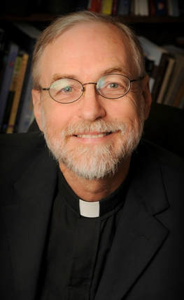 Image of Father Sullins with his priestly collar and a smile.